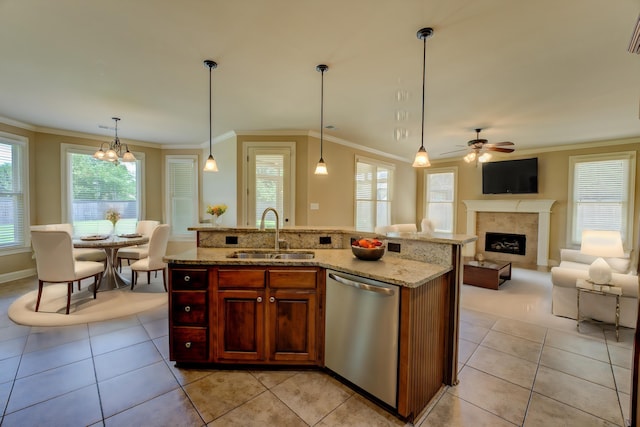 kitchen with sink, dishwasher, pendant lighting, and an island with sink