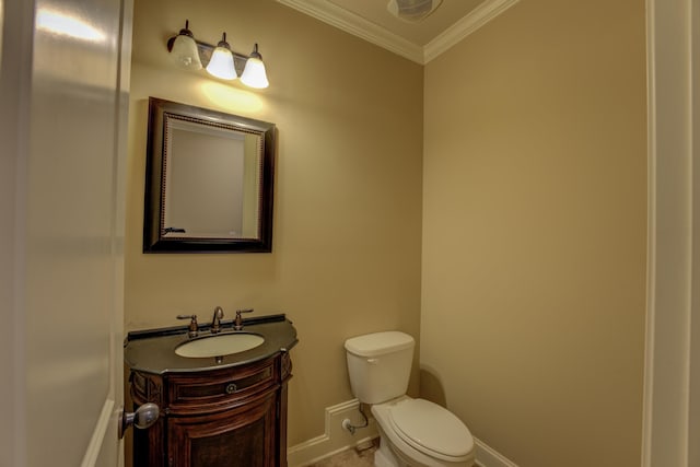 bathroom with ornamental molding, vanity, and toilet