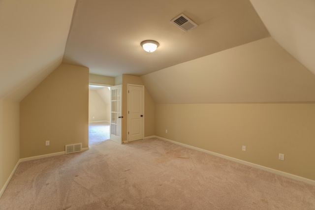 bonus room featuring vaulted ceiling and light carpet