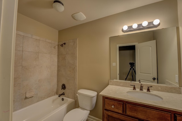 full bathroom with toilet, tiled shower / bath combo, and vanity