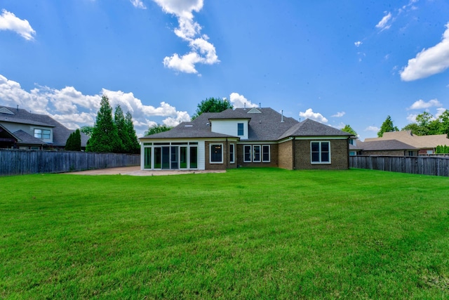 rear view of property with a patio area and a yard