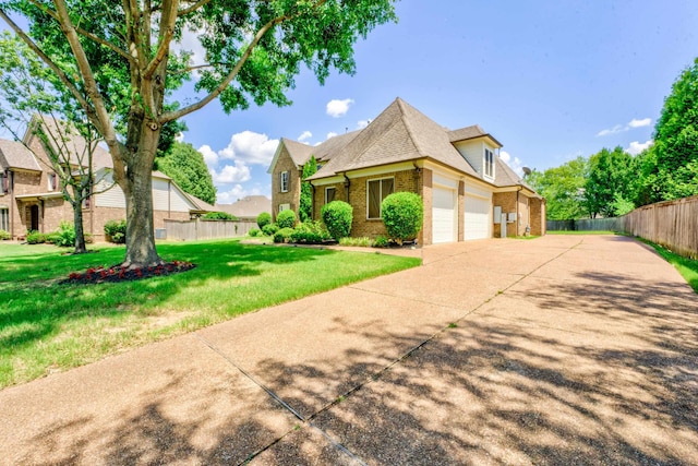 view of front of property with a front yard and a garage