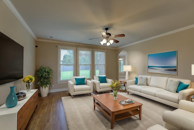 living room featuring wood-type flooring, ceiling fan, and crown molding