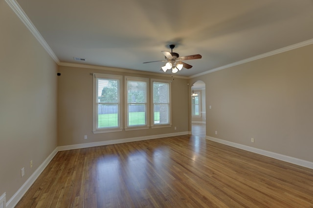 spare room with ceiling fan, crown molding, and hardwood / wood-style flooring