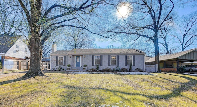 ranch-style house with a carport and a front lawn