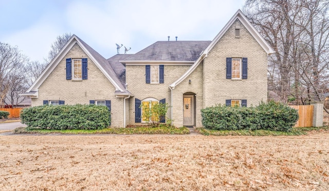 tudor-style house featuring a front lawn