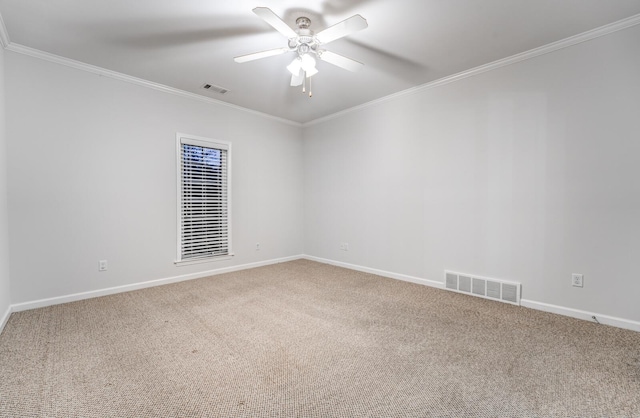 carpeted spare room with ceiling fan and crown molding