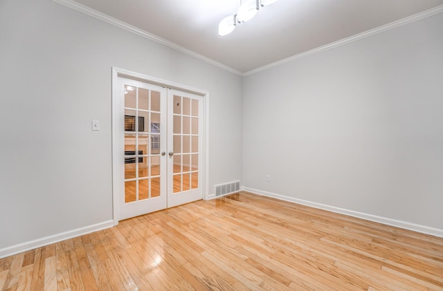 empty room with light hardwood / wood-style floors, french doors, and ornamental molding