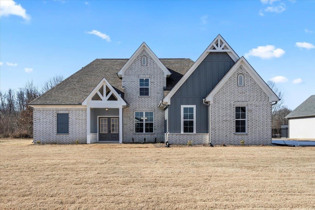 view of front of house featuring french doors and a front lawn