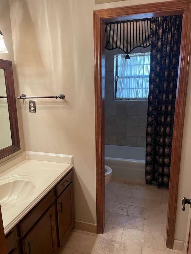 full bathroom featuring shower / tub combo with curtain, vanity, and toilet