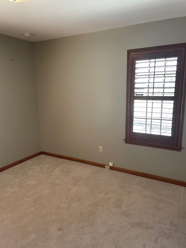 unfurnished room with light carpet