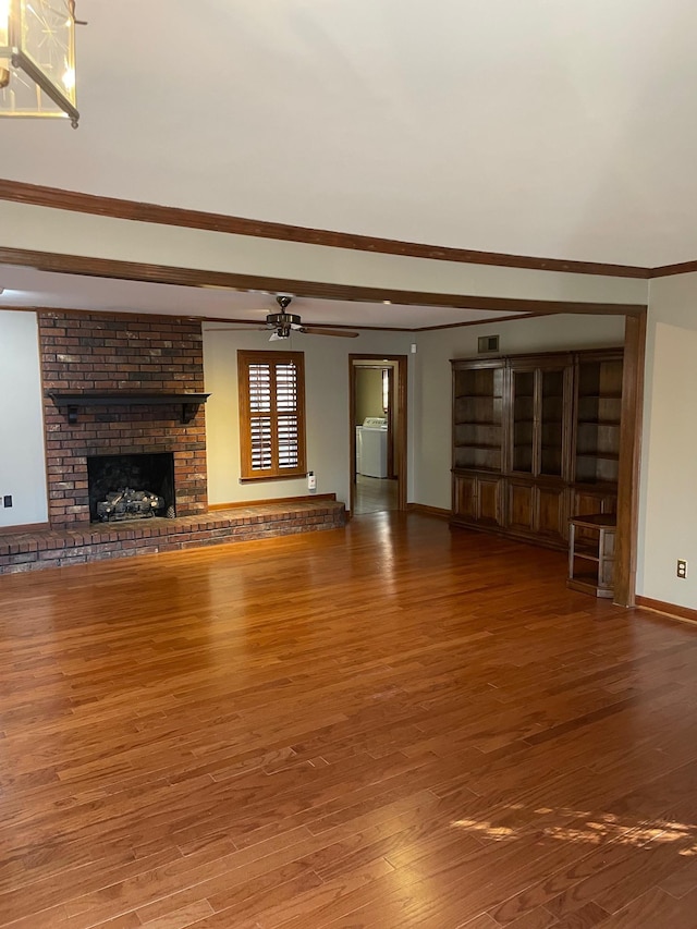 unfurnished living room featuring a fireplace, washer / clothes dryer, ceiling fan, and wood-type flooring