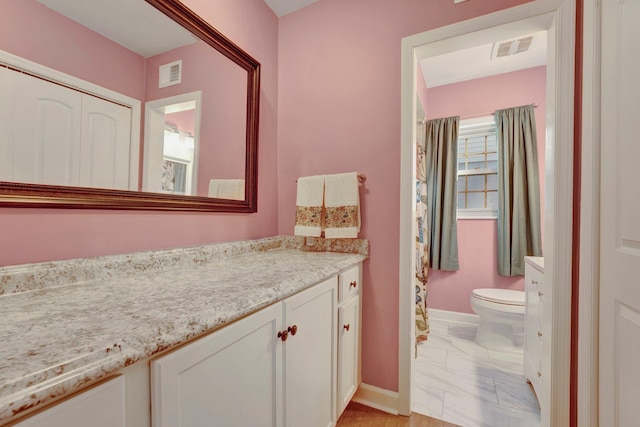 bathroom featuring vanity and toilet