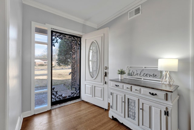 foyer featuring ornamental molding and wood-type flooring