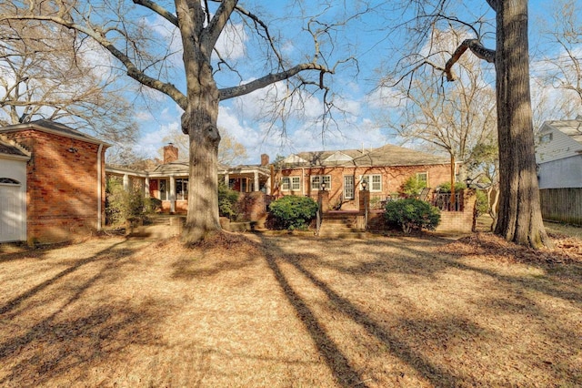 back of house with a lawn