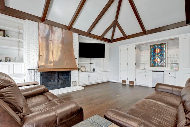 living room with beamed ceiling, dark hardwood / wood-style flooring, a fireplace, sink, and built in shelves