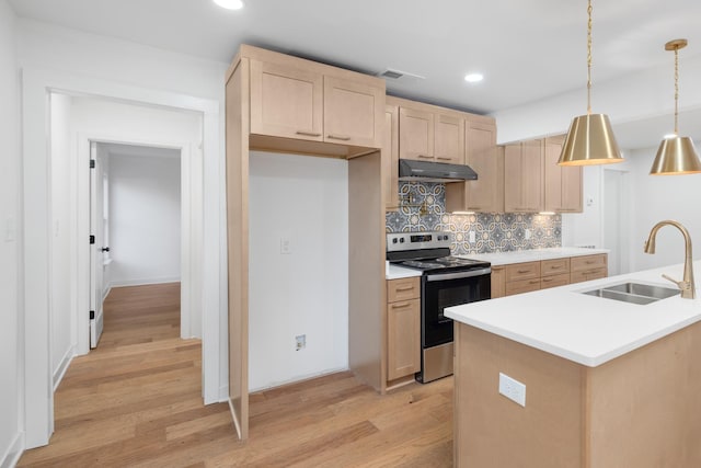 kitchen featuring sink, light brown cabinets, decorative backsplash, stainless steel range with electric stovetop, and pendant lighting