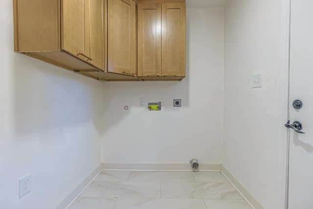 laundry area featuring hookup for a washing machine, cabinets, hookup for an electric dryer, and hookup for a gas dryer