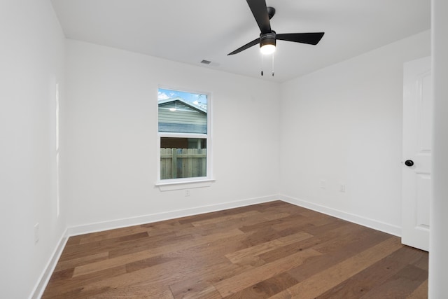 spare room featuring ceiling fan and dark wood-type flooring