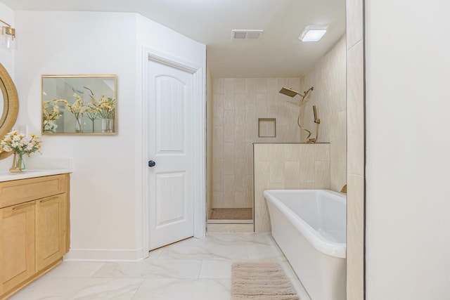 bathroom with vanity and shower with separate bathtub