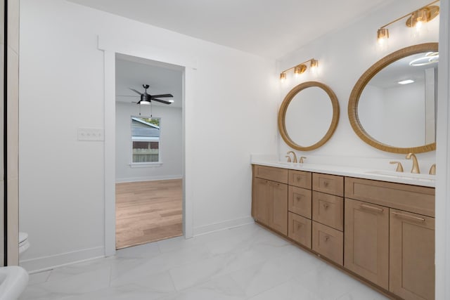 bathroom featuring toilet, vanity, and ceiling fan