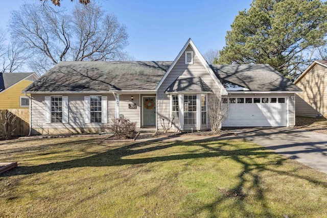 tudor house featuring a front yard and a garage