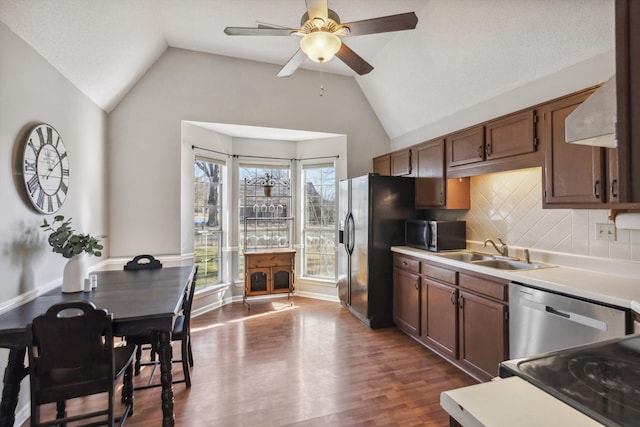 kitchen featuring black appliances, lofted ceiling, backsplash, ceiling fan, and sink