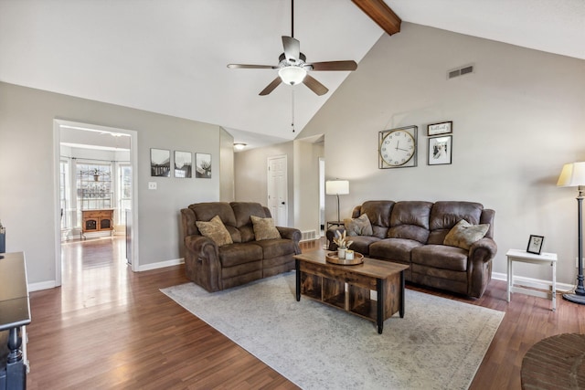 living room with ceiling fan, vaulted ceiling with beams, and dark wood-type flooring