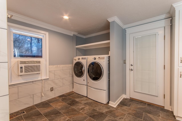 laundry room featuring a textured ceiling, washer and clothes dryer, tile walls, cooling unit, and ornamental molding