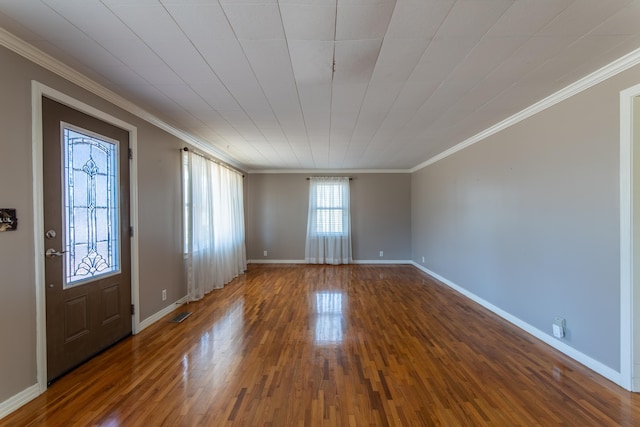 foyer entrance with crown molding and dark hardwood / wood-style floors