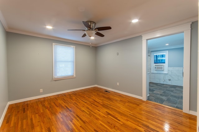 unfurnished room featuring cooling unit, ceiling fan, crown molding, and wood-type flooring