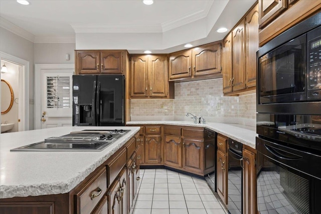 kitchen featuring light tile patterned floors, black appliances, tasteful backsplash, crown molding, and sink