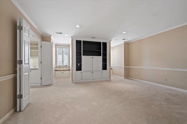 carpeted spare room featuring crown molding