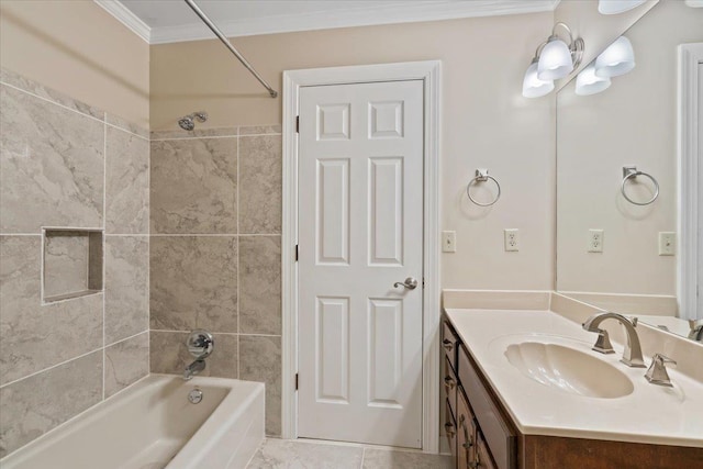 bathroom with crown molding, vanity, and tiled shower / bath