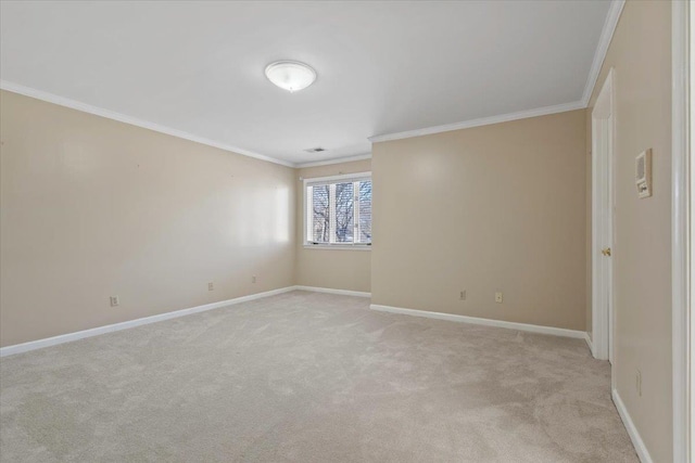 spare room featuring ornamental molding and light colored carpet