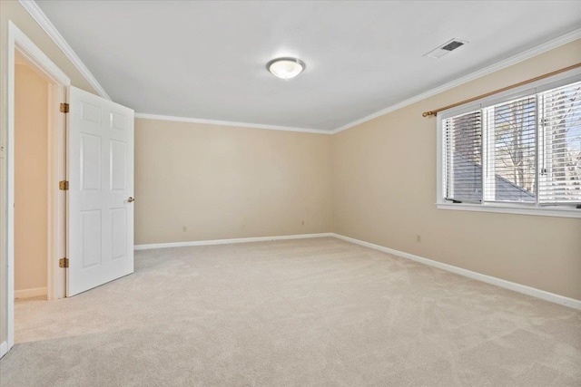 empty room featuring ornamental molding and light carpet