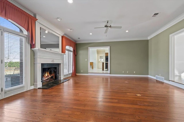 unfurnished living room featuring ceiling fan, crown molding, and dark hardwood / wood-style flooring