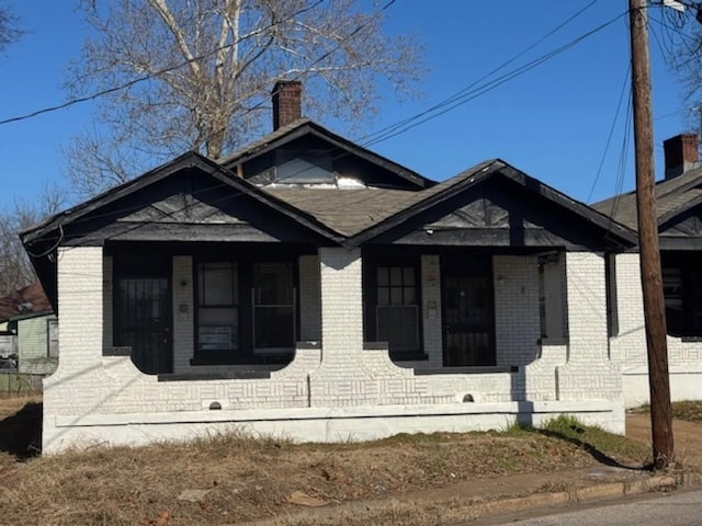 view of side of home featuring covered porch