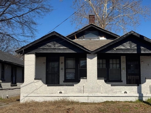 view of side of home with covered porch