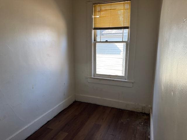 spare room with dark wood-type flooring