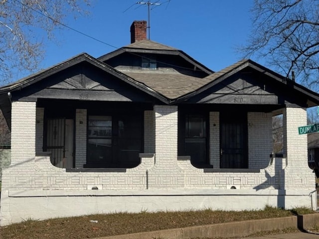 view of side of property featuring covered porch