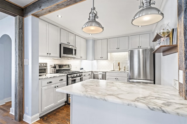 kitchen featuring sink, white cabinetry, light stone countertops, dark hardwood / wood-style flooring, and appliances with stainless steel finishes