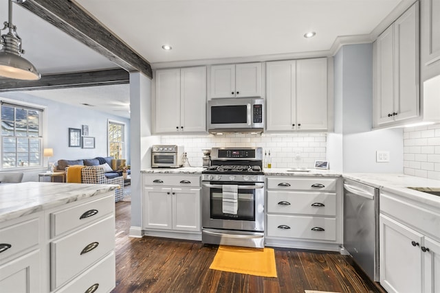 kitchen with dark wood-type flooring, appliances with stainless steel finishes, white cabinetry, and beam ceiling