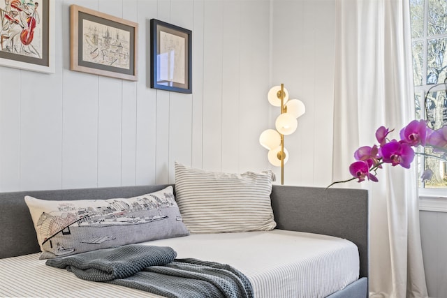 bedroom with wooden walls