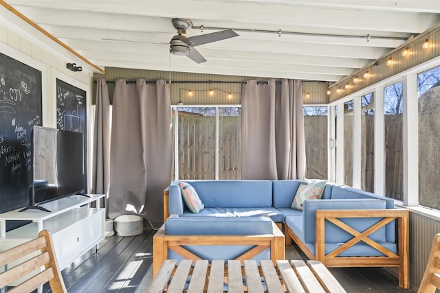 sunroom featuring ceiling fan and beam ceiling