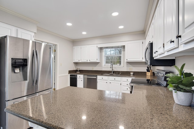 kitchen with kitchen peninsula, crown molding, white cabinets, appliances with stainless steel finishes, and sink