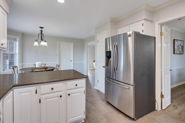 kitchen featuring ornamental molding, white cabinetry, a notable chandelier, and stainless steel fridge with ice dispenser