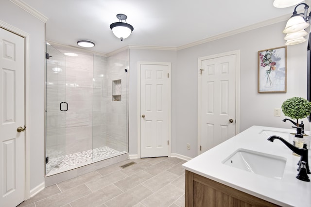 bathroom featuring an enclosed shower, vanity, and ornamental molding