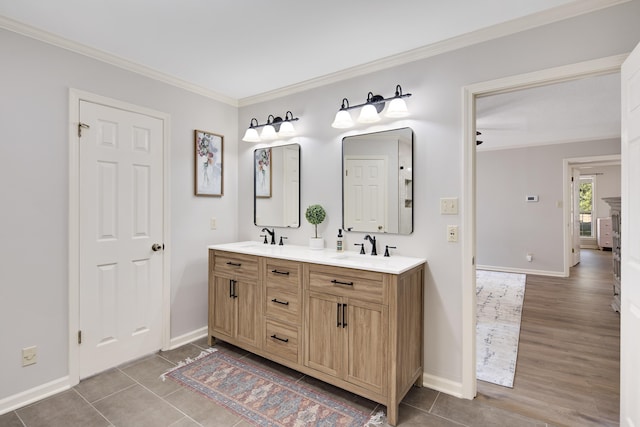 bathroom featuring tile patterned floors, crown molding, and vanity