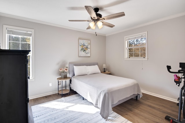 bedroom with wood-type flooring, multiple windows, ceiling fan, and ornamental molding